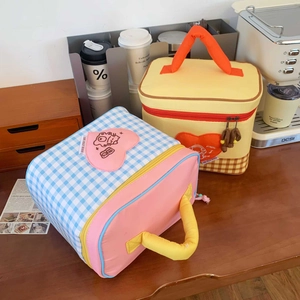 Close-up of insulated cartoon lunch bags with thick handles and checkered patterns