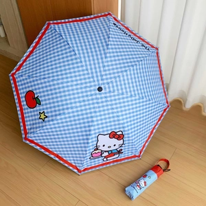 Detail of Hello Kitty blue plaid umbrella with matching storage pouch on floor
