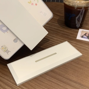 Minimalist white plastic desktop calendar holder base with a sleek slot design