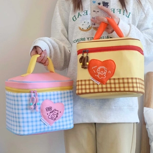 Close-up of cute cartoon thermal lunch bags with heart embroidery and doll zippers