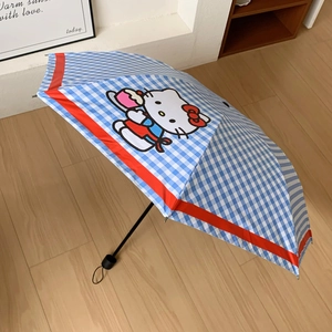 Detail view of Hello Kitty cartoon pattern on blue and white checkered folding umbrella
