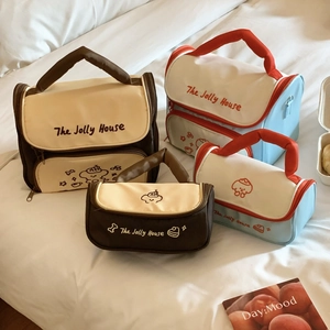 Detail view of large and small canvas tote bags with cute puppy prints and handles
