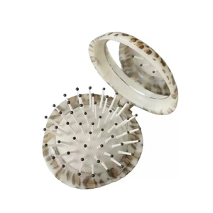 Portable folding leopard print hairbrush with integrated makeup mirror and massage bristles