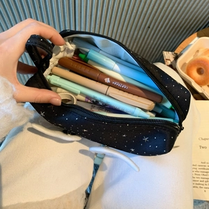Internal view of star pattern pencil case with wing detail showing large storage capacity