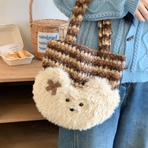 Detail of cute plush teddy bear tote bag with textured fleece stripes and cozy bow