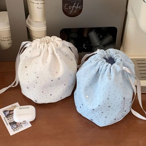 Detail of drawstring star pouches in blue and white with satin ribbons and glitter stars