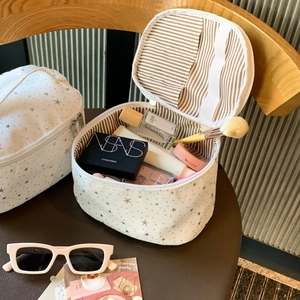 Interior view of star print makeup bag showing dual compartments and striped lining