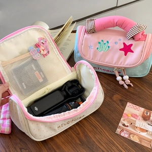 Detailed interior view of the large capacity pencil case with mesh pockets and dividers