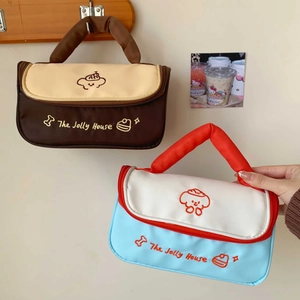 Detail of cute puppy cosmetic bags with sturdy handles and cartoon patterns