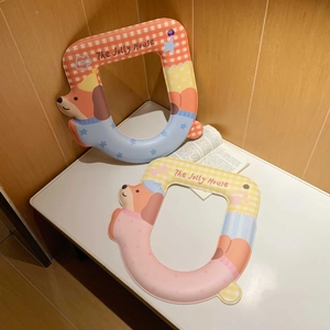Detail of waterproof U-shaped toilet seat cushions with cute cartoon dog prints