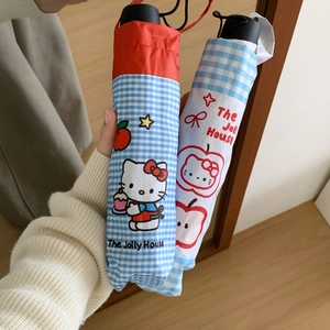 Detail of Hello Kitty themed folding umbrella with cartoon prints and matte black handle