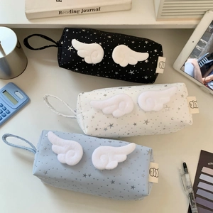 Detailed view of canvas pencil cases with 3D plush wings and silver star patterns