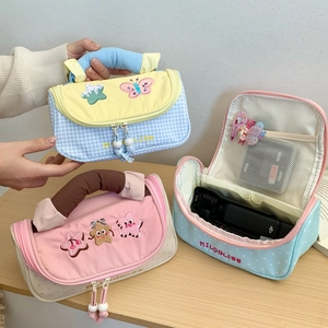 Detail of colorful multi-pocket stationery bags with cute embroidery and top handles