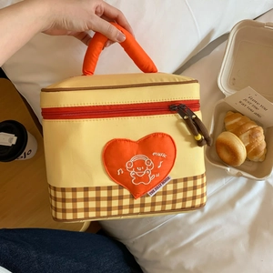 Detail of insulated lunch bag with orange heart embroidery and thick soft handle