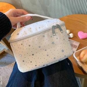 Macro view of portable travel makeup bag with silver stars and sturdy top handle