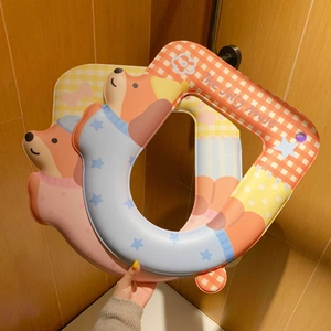 Detail of waterproof toilet seat cover with cartoon bear and checkered pattern design