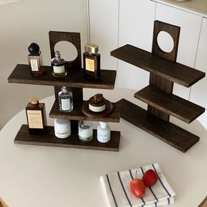Close-up of vintage dark wood multi-tier display rack with natural grain and round cutout