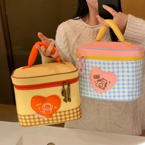 Close-up of cute cartoon thermal lunch bags with heart patches and double zippers