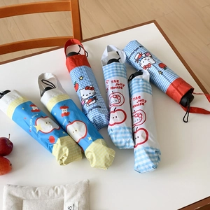 Close-up of portable star and apple pattern umbrellas with cartoon cat storage bags