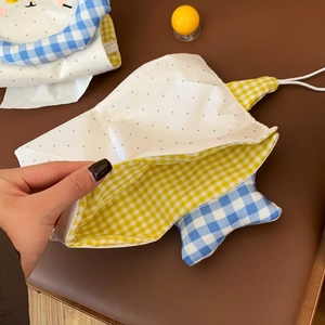 Detail of cute bear cartoon tissue pouch showing polka dot fabric and plaid lining