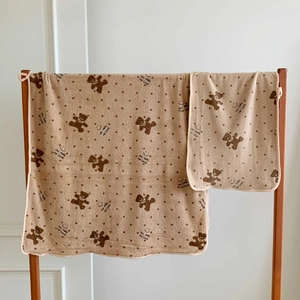 Detail view of khaki coral fleece towel featuring cute bear dots and soft textures