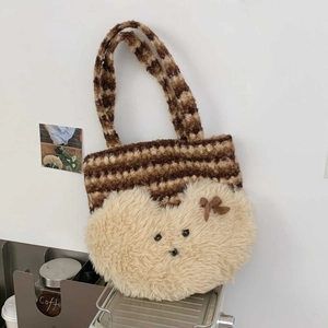 Detail of hand-woven striped tote bag with cute plush bear pocket and bow accent