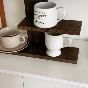 Detail of vintage dark wood tiered shelf with natural grain for tabletop storage