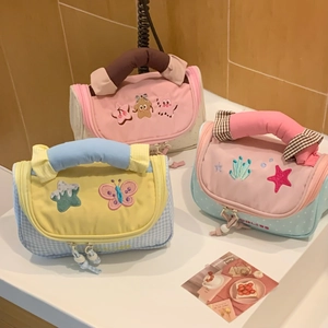 Detailed embroidery of starfish and butterflies on cute handheld stationery bags