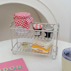Detail of double-layer stainless steel rack with mesh base for desktop organization
