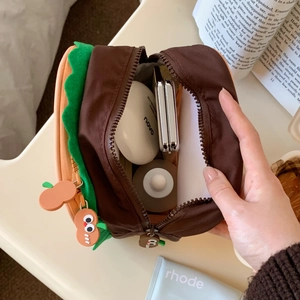 Macro view showing spacious interior storage of burger shaped portable makeup pouch