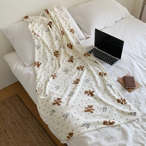 Cozy cream bear polka dot towel set displayed on bed with home lifestyle decor