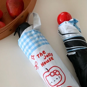 Detailed view of portable umbrellas with red ball handles and cute cat patterned covers