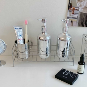 Close-up of silver stainless steel bathroom organizer with linear hollow frame structure