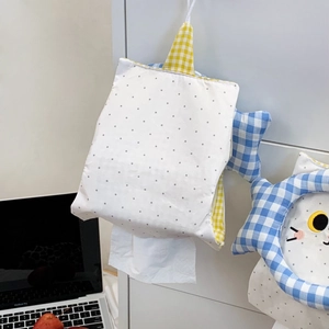 Close-up of cute cat embroidery on hanging fabric tissue box holder with polka dot pattern