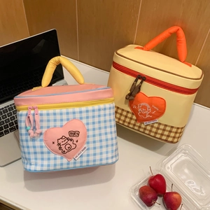 Close-up of insulated lunch bags with embroidery heart patches and double zippers