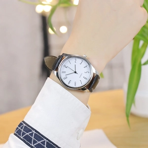 Men's fashion quartz watch with bamboo pattern leather strap worn in a lifestyle setting