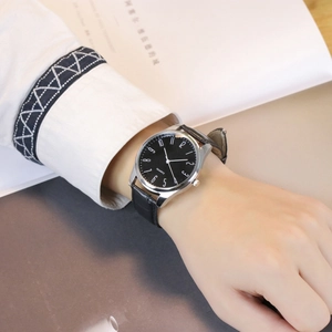Classic silver alloy quartz watch with black leather bamboo pattern strap worn on wrist