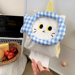 Close-up of cute cat tissue holder with blue checkered trim and embroidery details