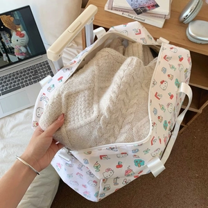 Interior view showing large capacity travel bag holding a thick cable-knit sweater