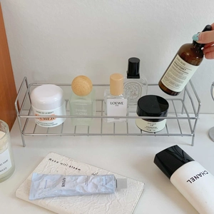 Macro detail of sleek double-layer stainless steel shelf organizer for cosmetics