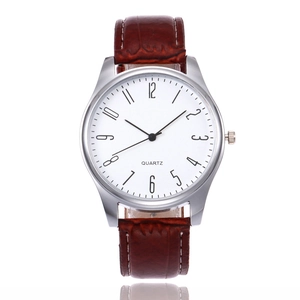 Detail of silver quartz watch with white dial and brown bamboo pattern leather strap