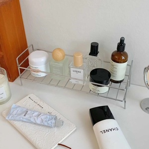 Detail of minimalist stainless steel wire organizer shelf with spherical protective feet