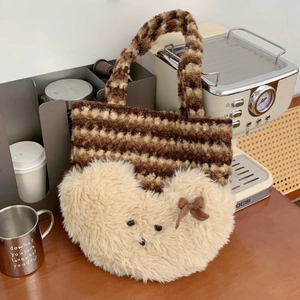 Close-up of the soft plush teddy bear detail and woven texture on a tote bag