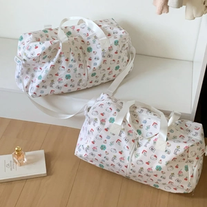 Close-up of Hello Kitty patterned duffel bag with side zipper and durable white handles