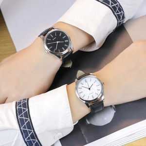 Close-up of minimalist quartz watches with black and white dials on bamboo leather straps