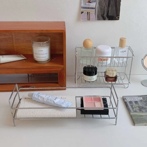 Detail view of silver tiered stainless steel organizers for cosmetics and skincare bottles