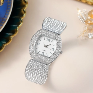 Macro shot of silver rhinestone watch featuring a sparkling hexagonal dial and crystal band