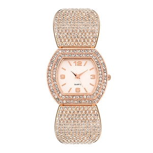 Detail of rose gold tonneau watch featuring high-density rhinestones and quartz dial