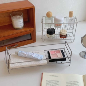 Close-up of industrial silver metal wire storage rack with elegant ball feet on wood