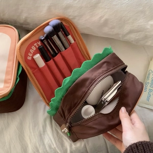 Detail of creative burger makeup bag with brush slots and large interior storage
